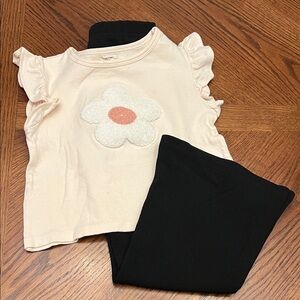 Cream Ruffle Sleeve Top with Flower and Black Bell Bottom Pants